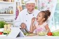 Man preparing dinner with granddaughter Royalty Free Stock Photo