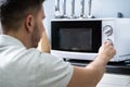 Man Preparing Food In Microwave Oven Royalty Free Stock Photo