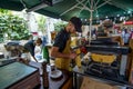 Man preparing french fries with melted cheese in one of the London`s borrow market