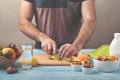 Man preparing a fruit salad in the kitchen at home Royalty Free Stock Photo