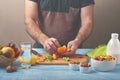 Man preparing a fruit salad in the kitchen at home Royalty Free Stock Photo