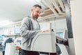 Man preparing large format printer for a print job