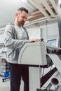 Man preparing large format printer for a print job