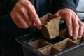 Man is preparing paper pots for seedlings. Seasonal garden