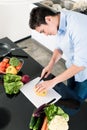 Man preparing salad and cooking in kitchen Royalty Free Stock Photo