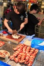 Man preparing squid to be sold in a night market of Kaohsiung City