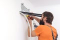 Man preparing to install new air conditioner. Modern air conditioner during the installation process Royalty Free Stock Photo