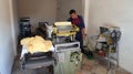 Man preparing tortillas in a machine