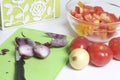 A man is preparing a vegetable salad. He cuts the onion on a cutting board. Royalty Free Stock Photo