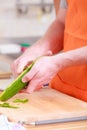 Man preparing vegetables salad peeling cucumber