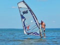 A man preparing for windsurfing on Plescheevo lake near the town of Pereyaslavl-Zalessky in Russia.