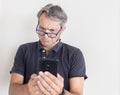 Man with presbyopia looking the smart phone