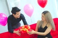 A man present a gift to his girl friend in the special occasion
