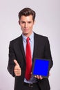 Man presentig tablet and showing thumb up Royalty Free Stock Photo