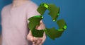 Man presenting a 3D rendered green recycle sign