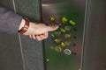 Man press button in elevator with germs, closeup Royalty Free Stock Photo