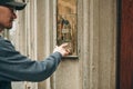 Man presses a doorphone button Royalty Free Stock Photo