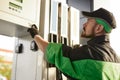 Man pressing buttons on gas pump at station Royalty Free Stock Photo