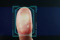 Man pressing control glass of biometric fingerprint scanner on color background, closeup with space for text. Royalty Free Stock Photo