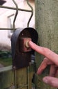 Man pressing a doorbell button with his finger