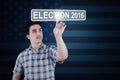 Man pressing election button with number 2016 Royalty Free Stock Photo