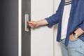 Man pressing elevator call button, closeup view Royalty Free Stock Photo