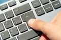 Man pressing the enter key on a modern computer keyboard, top view, hand finger detail, closeup Accepting, confirming, purchasing Royalty Free Stock Photo