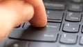 Man pressing the enter key on a modern laptop computer keyboard, macro detail closeup, user POV, shallow DOF, one person. Sending
