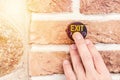 Man pressing exit button on the brick wall. Close up image Royalty Free Stock Photo