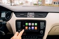 Man pressing home button on the Apple CarPlay main screen
