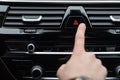 Man pressing red triangle car hazard warning button