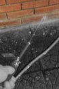 Man pressure washing brick wall with a power wand.  Home maintenance concept Royalty Free Stock Photo