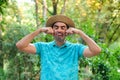 Man pretending that is crying because summer vacation is over with a straw hat. Royalty Free Stock Photo