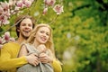 Man and pretty girl or cute woman enjoying pink magnolia Royalty Free Stock Photo