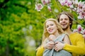 Man and pretty girl or cute woman enjoying pink magnolia Royalty Free Stock Photo