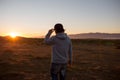 Man in a pristine landscape during a beautiful blazing sunset Royalty Free Stock Photo