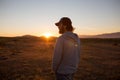 Man in a pristine landscape during a beautiful blazing sunset