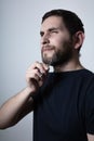 Man with problem of graying beard Plucking Hair with Tweezers from beard Royalty Free Stock Photo