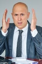 Man with problems and stress in the office. Office manager raising hands to head.Stressed man in office at workplace Royalty Free Stock Photo