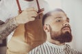 Man in the process of trimming a beard in a barbershop Royalty Free Stock Photo