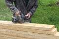 The man processes a board a electric planer outdoors Royalty Free Stock Photo