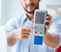 Man processing credit card transaction with POS terminal Royalty Free Stock Photo