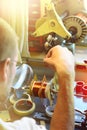 A man producing an electrical copper coil for high-voltage trans