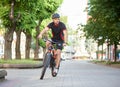 Cyclist riding along empty city streets Royalty Free Stock Photo