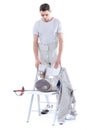 Man professional fencer looking at fencing equipment on chair