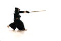 Man, professional kendo athlete in uniform with helmet training with bamboo shinai sword against white studio background Royalty Free Stock Photo