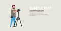 Man professional photographer taking photo guy using dslr camera on tripod horizontal full length flat copy space Royalty Free Stock Photo