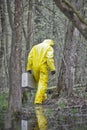 Man in professional uniform with silver suitcase walking in contaminated floods area