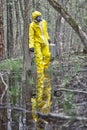 Man in professional uniform walking in contaminated floods area