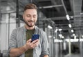 Man professional using smartphone in office. Businessman working, texting on mobile phone.